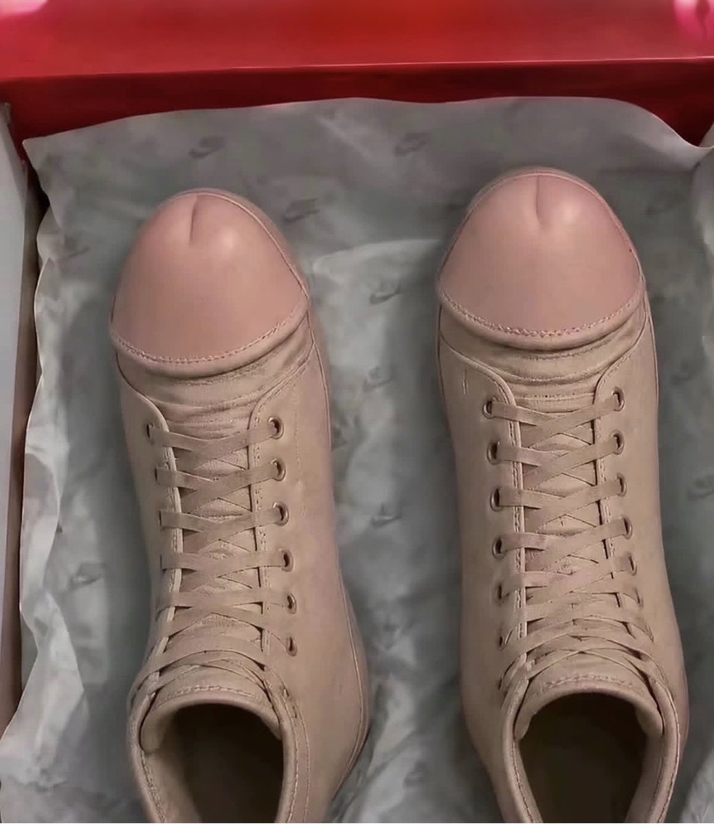 A pair of beige-pink leather sneakers in a shoebox, with toes shaped like penises—the literal $COCKWALKERS meme image.